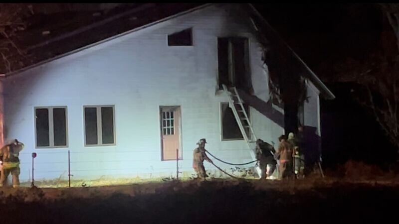 Firefighters work on a house fire.