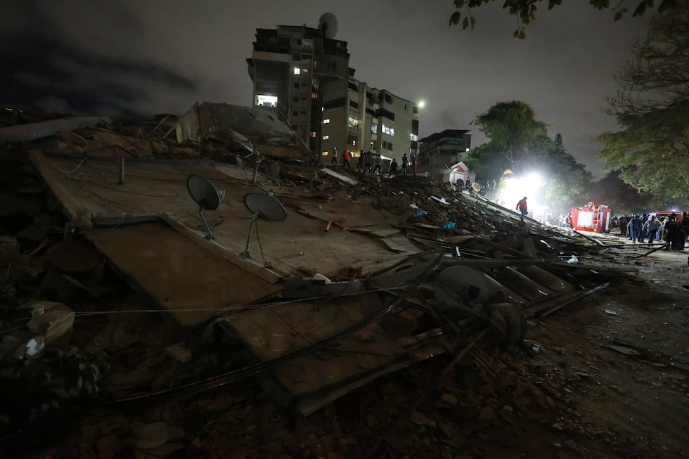 Los equipos de rescate buscan entre los escombros de un edificio derrumbado tras un terremoto...